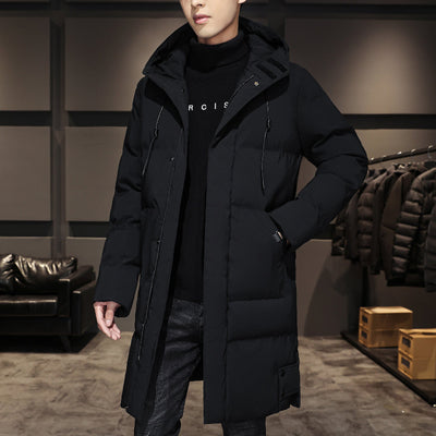 A black parka jacket with a hood and a zippered front. The parka is worn over a black shirt and jeans.