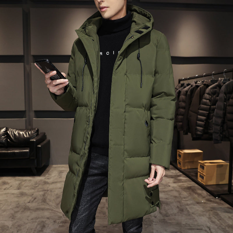 An olive green parka jacket with a hood and a zippered front. The parka is worn over a black shirt and jeans.