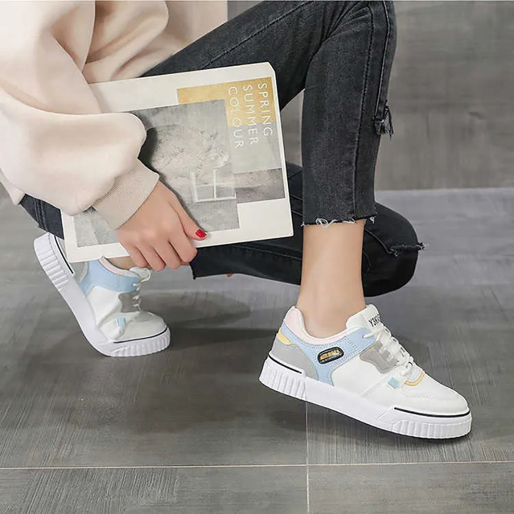 Woman wearing casual sneakers outdoors paired with jeans, highlighting comfort and style.
