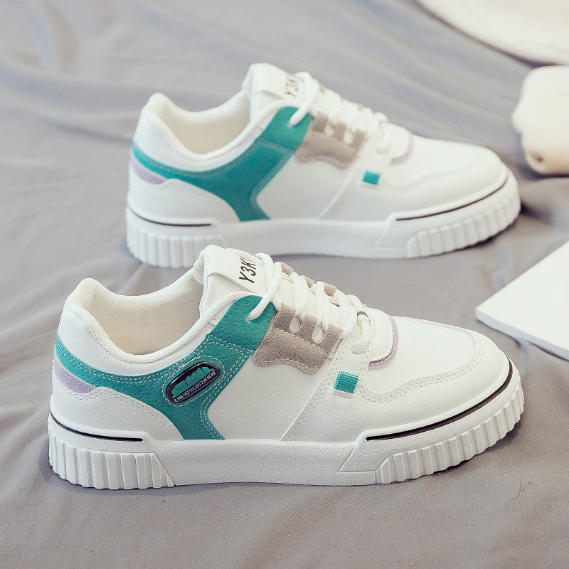 Side profile of white and teal sneakers with a modern and breathable look.