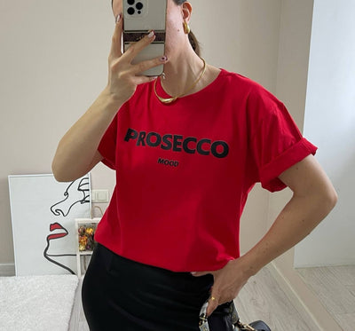 A red women's t-shirt with "PROSECCO MOOD" text printed on the front.