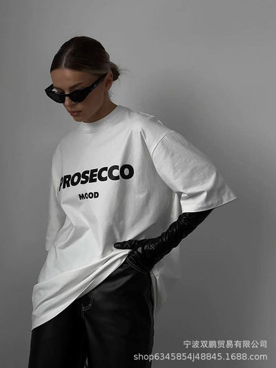 A white women's t-shirt with "PROSECCO MOOD" text printed on the front.